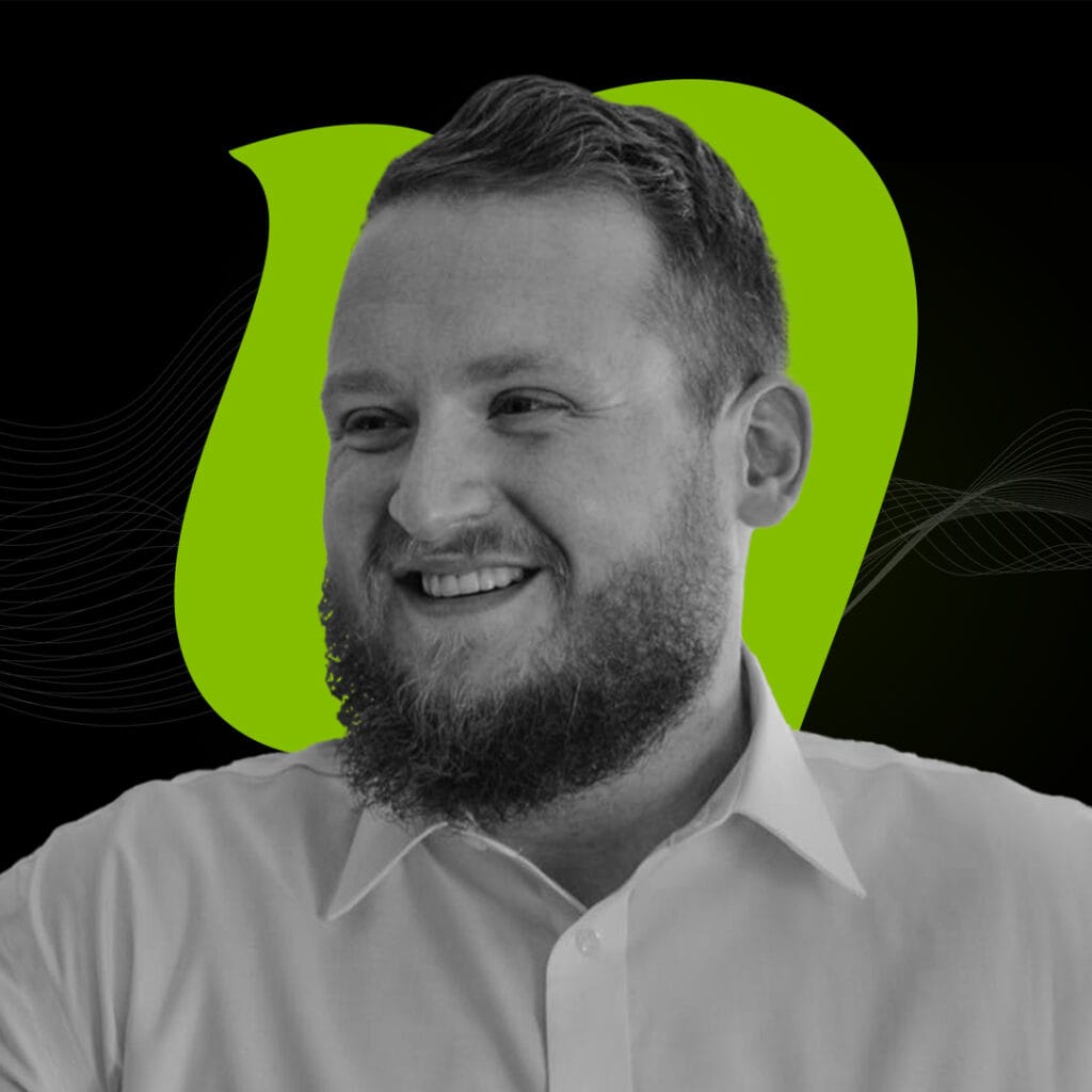 Professional digital marketing expert smiling in a modern office environment with Neo Digital branding in the background.