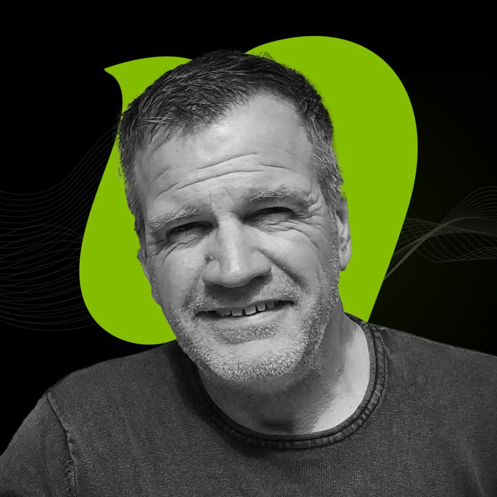 Happy middle-aged man smiling with short gray hair in a black and white portrait, modern digital background emphasizing technology and innovation concepts.