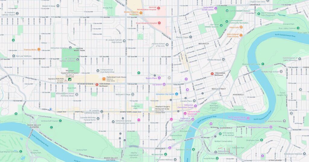 Detailed city map highlighting streets, parks, and the river in the downtown area. Features various landmarks, transportation routes, and green spaces for urban navigation.